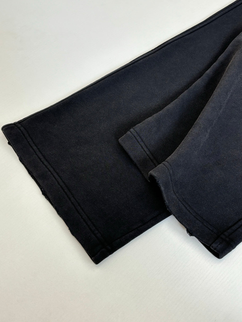Folded black Balenciaga pants, seam details on tapered legs