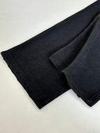 Folded black Balenciaga pants, seam details on tapered legs
