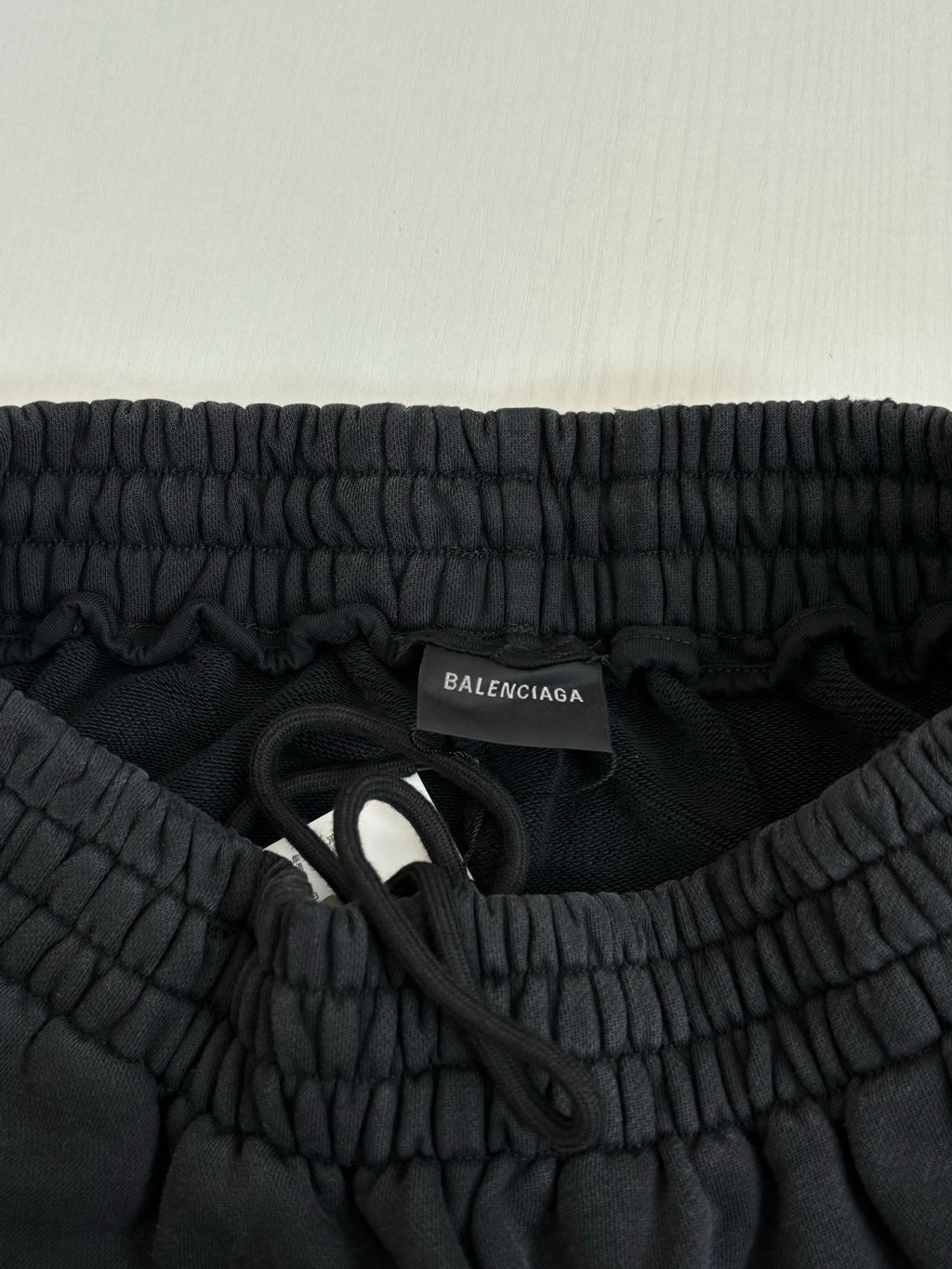 Black Balenciaga pants waistband with inner neck label and fabric ruching