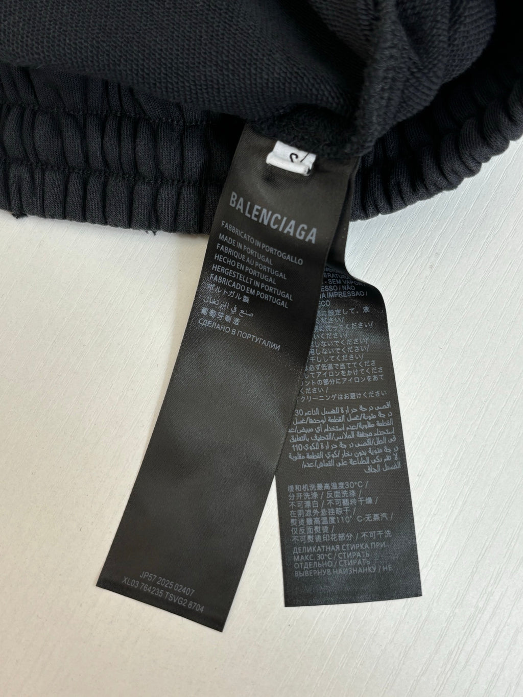 Balenciaga care label on black track pants inner waistband