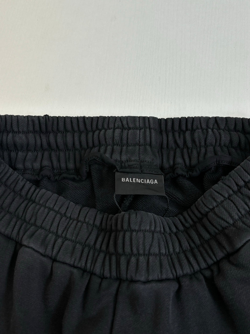 Black track pants with gathered elastic waistband and Balenciaga size label inside