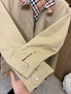 Beige jacket long sleeve with snap cuffs and plaid-lined hood