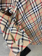 Beige jacket hood lining with Burberry plaid check pattern and snap button