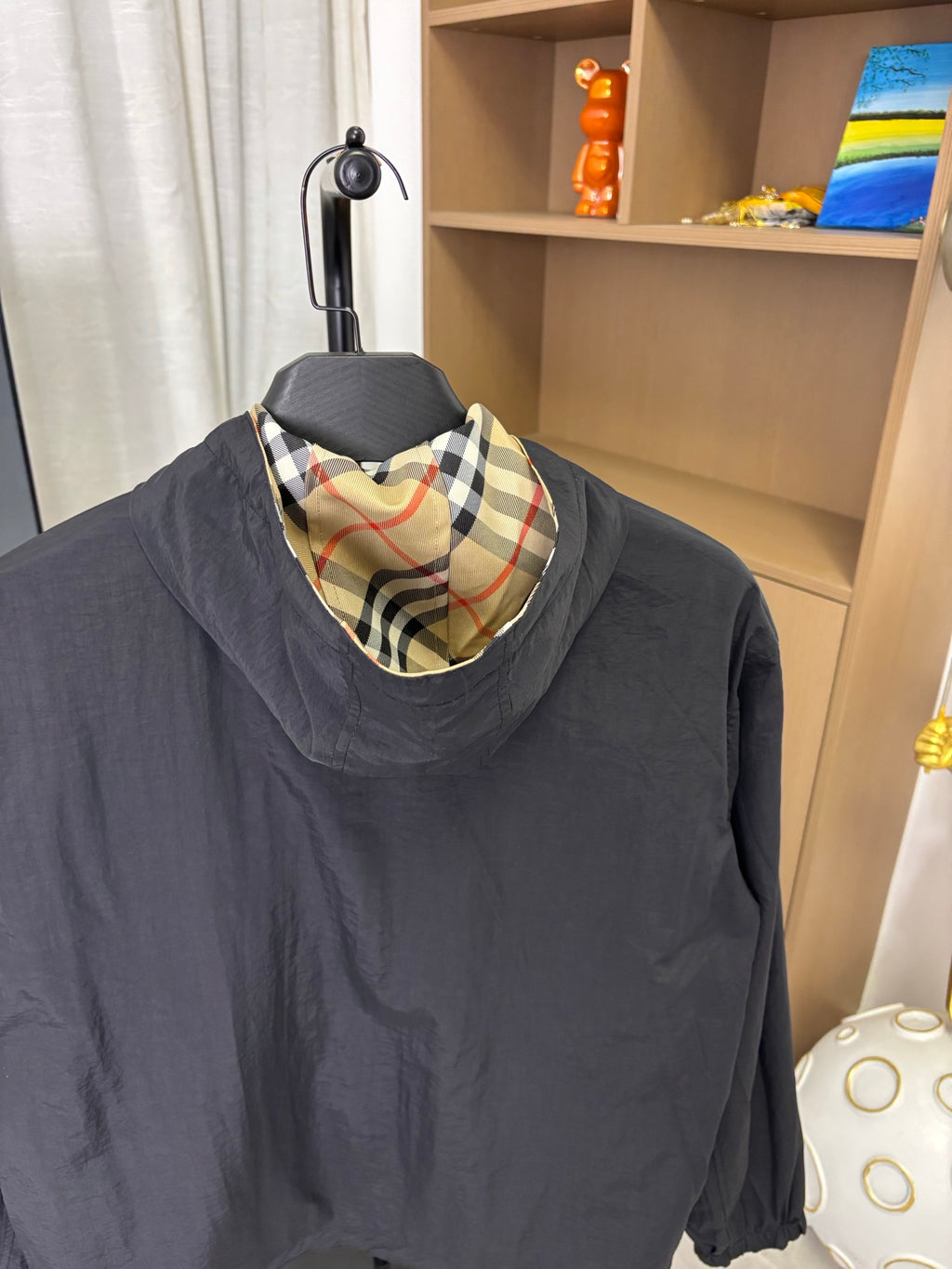 Burberry long jacket with dark navy body and plaid hood lining
