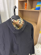 Burberry long jacket with dark navy body and plaid hood lining