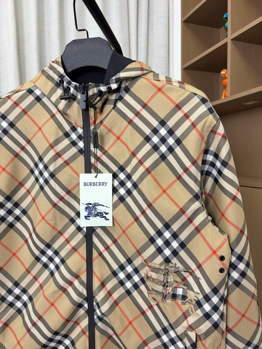 Burberry plaid hooded zip jacket, close-up of logo tag and front zipper