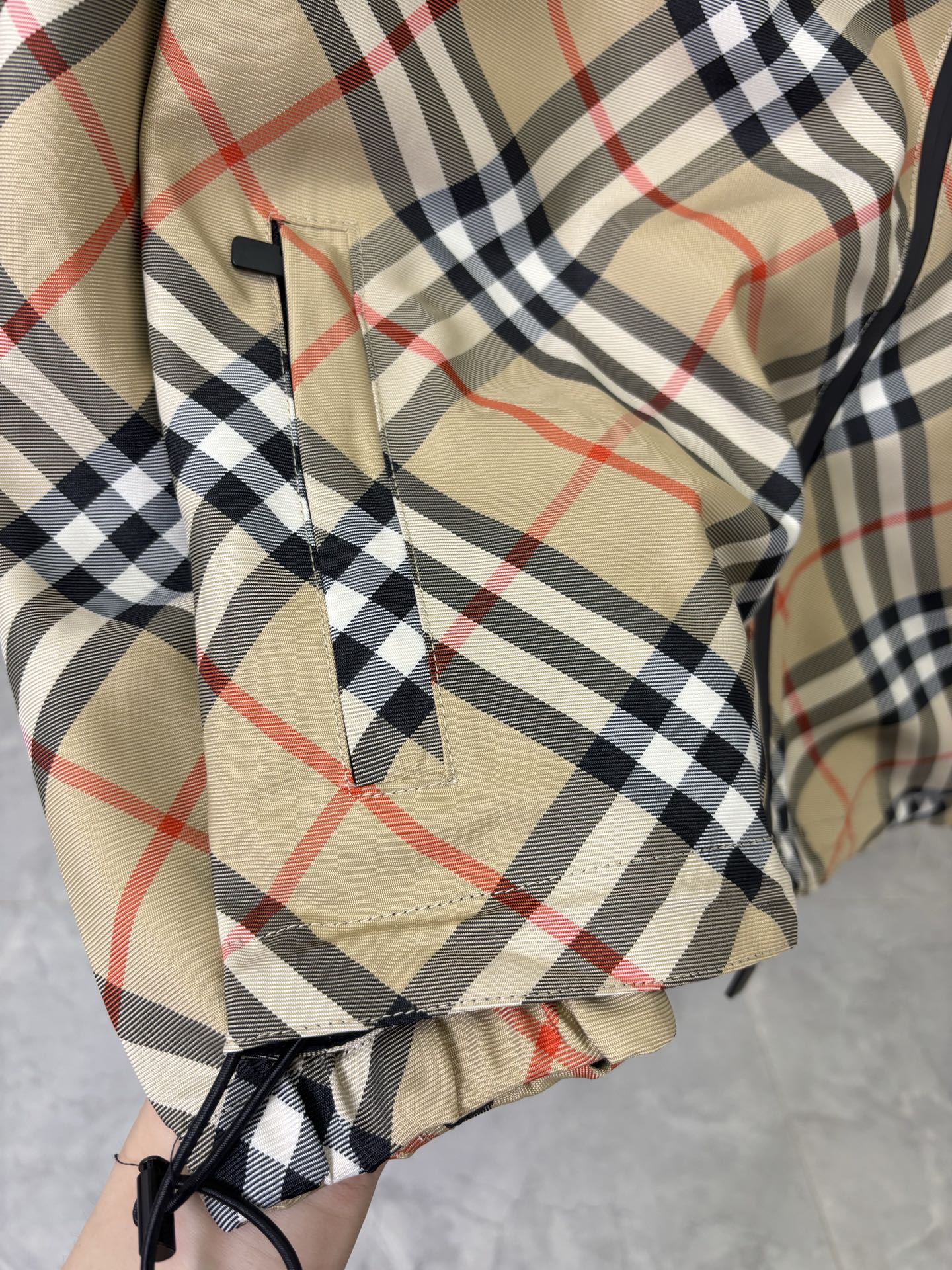 Burberry long jacket close-up of beige, navy, and red plaid hood lining