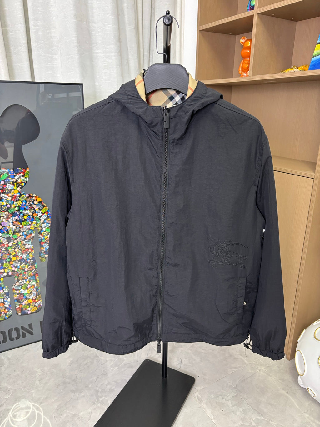 Navy hooded zip jacket with stand collar and side snap details