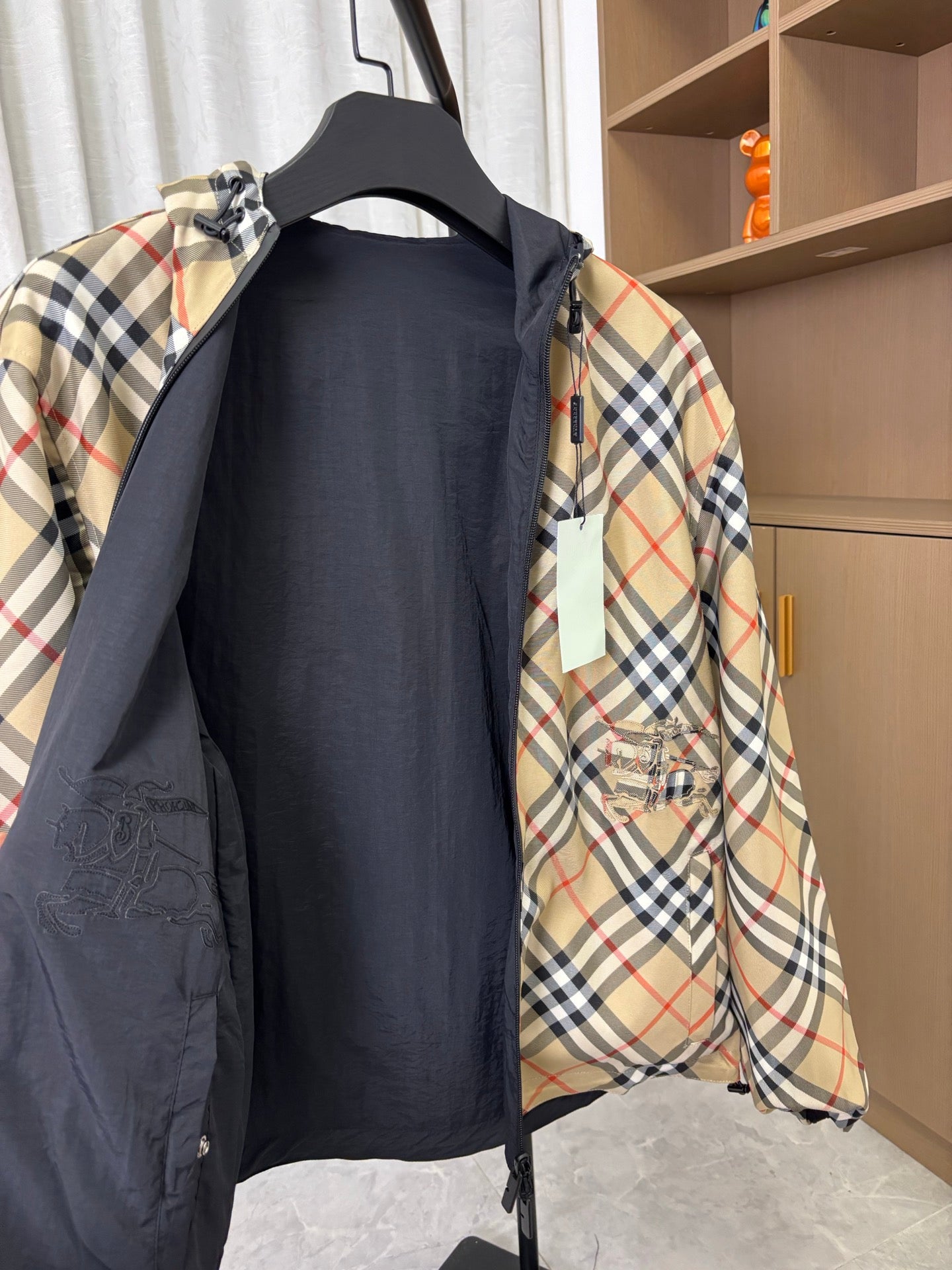 Plaid hooded jacket with navy inner panel and front pocket detail