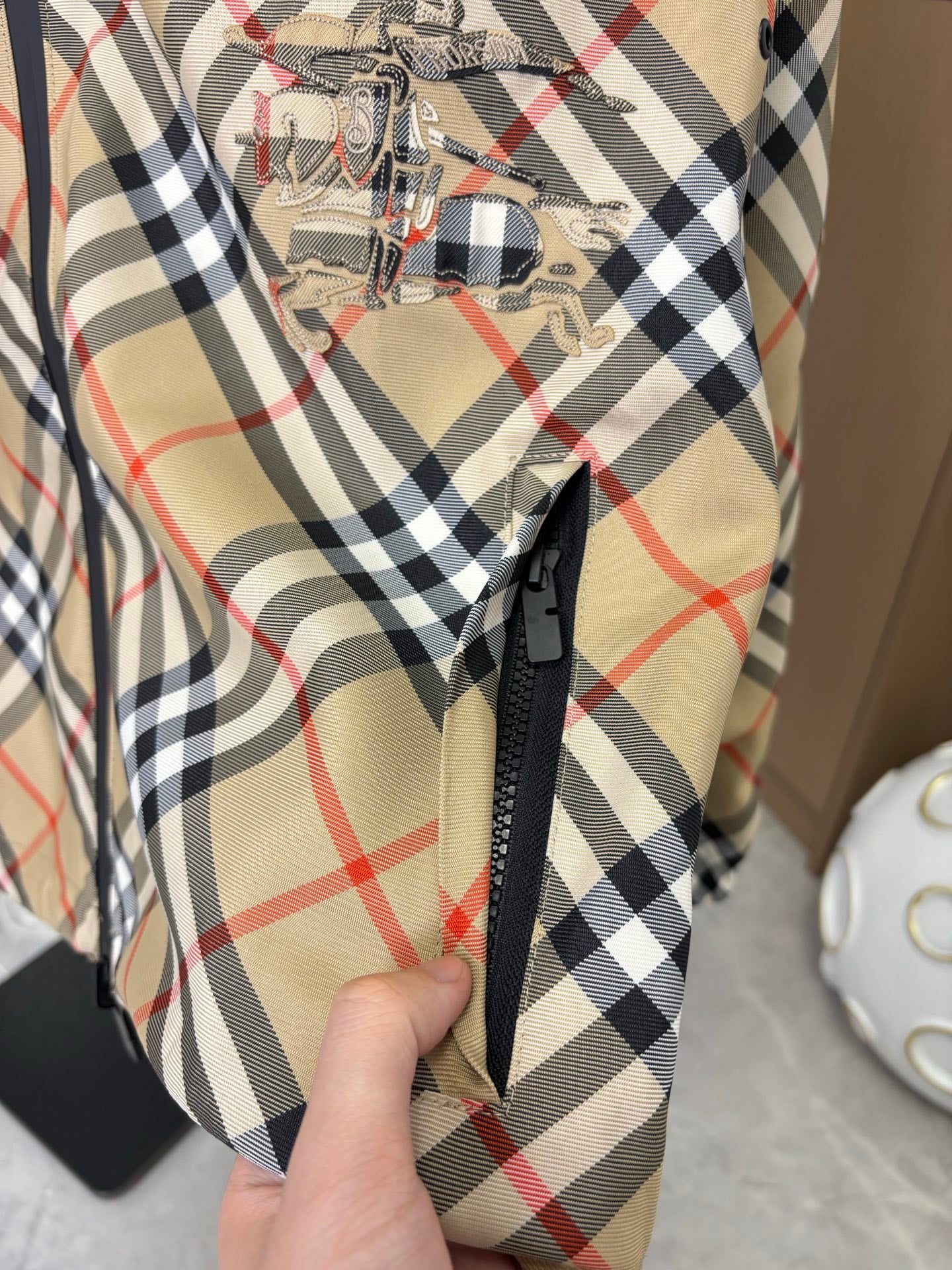 Burberry long jacket plaid front with black zipper and embroidered crest