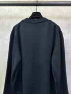 Dark navy knit sweater, crew neckline and ribbed cuffs, back view