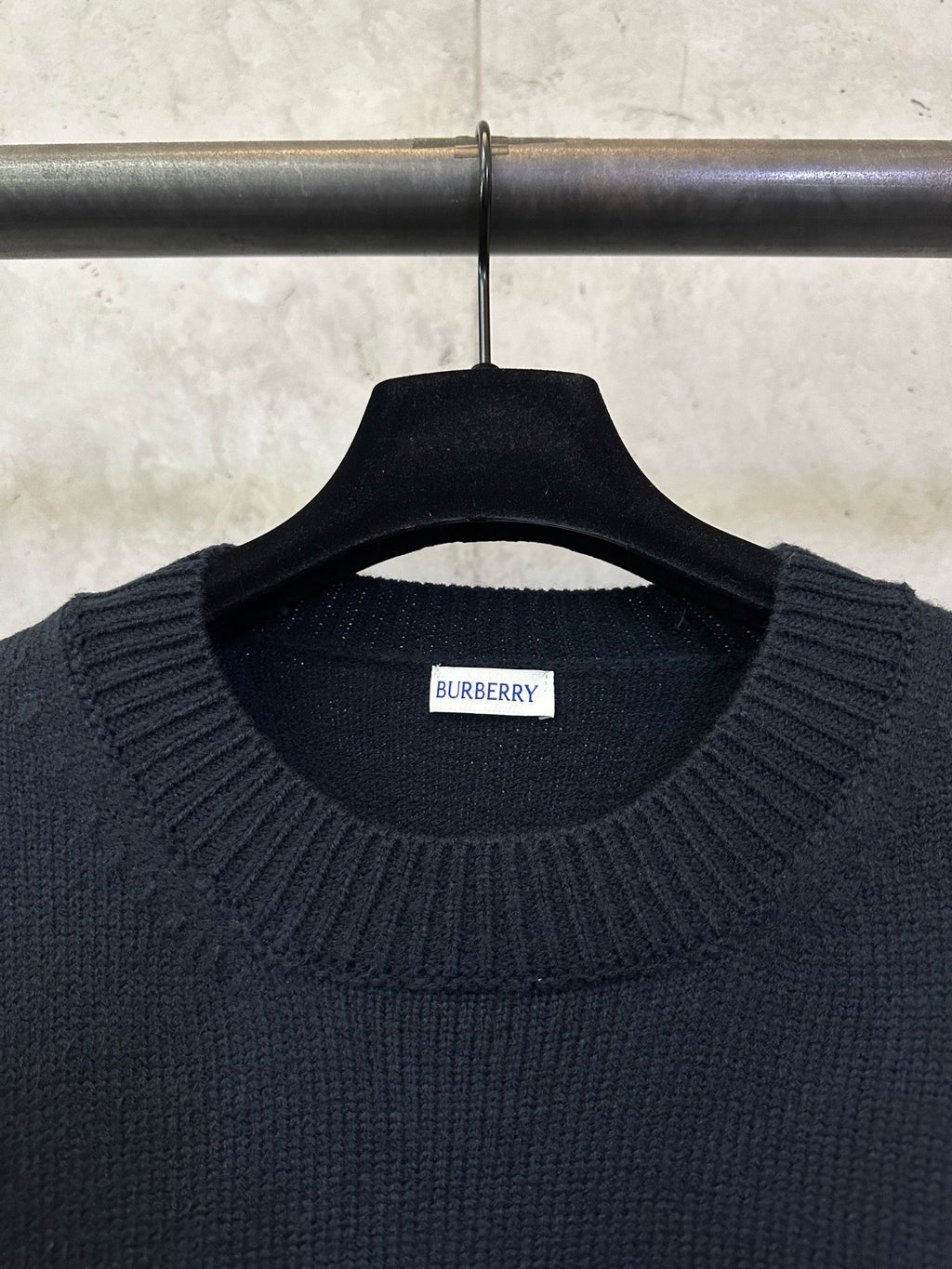 Dark navy knit sweater neckline with Burberry label on the inside