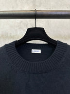 Dark navy knit sweater neckline with Burberry label on the inside