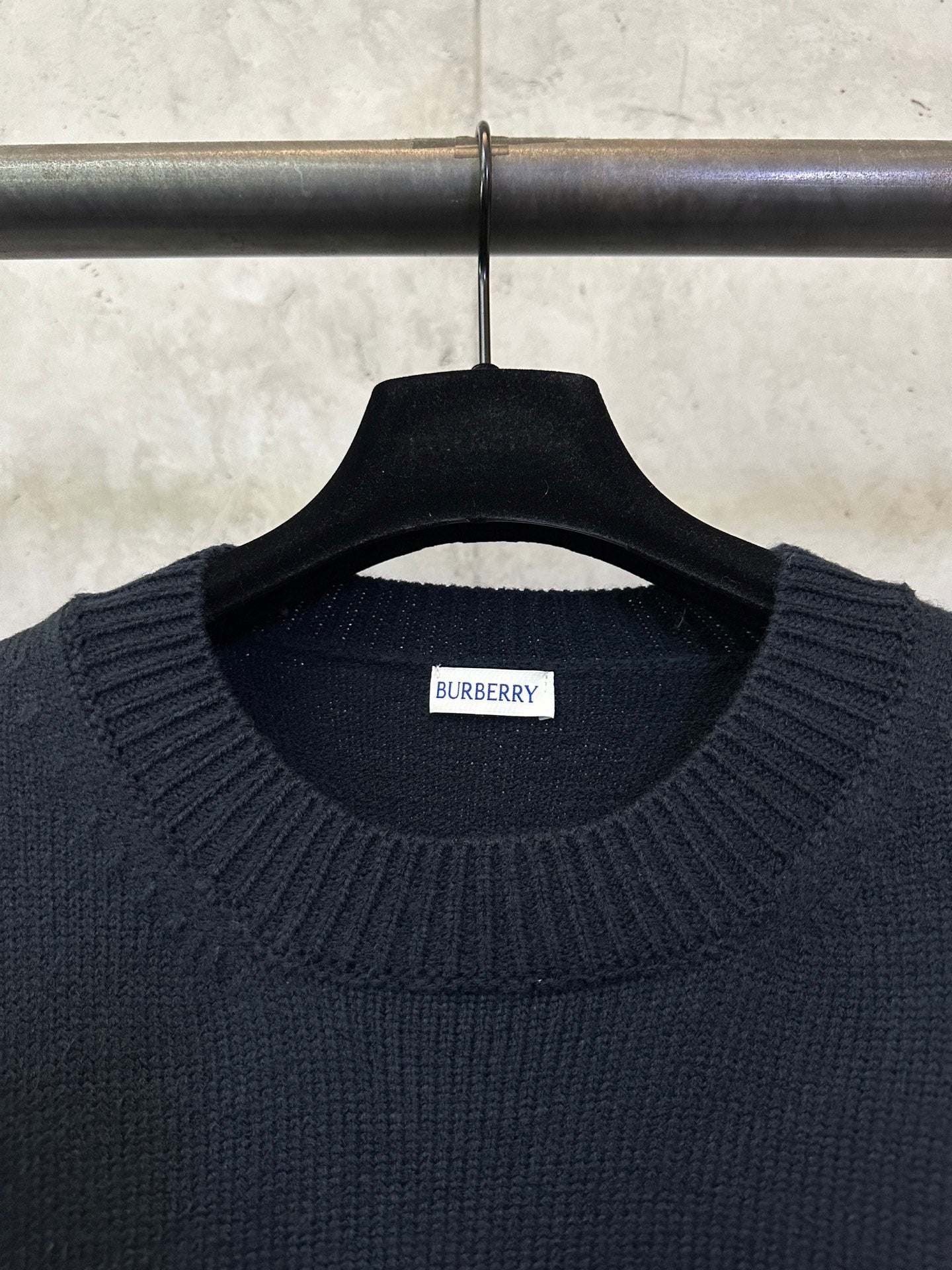 Burberry knit sweater neckline with brand label on dark ribbed collar