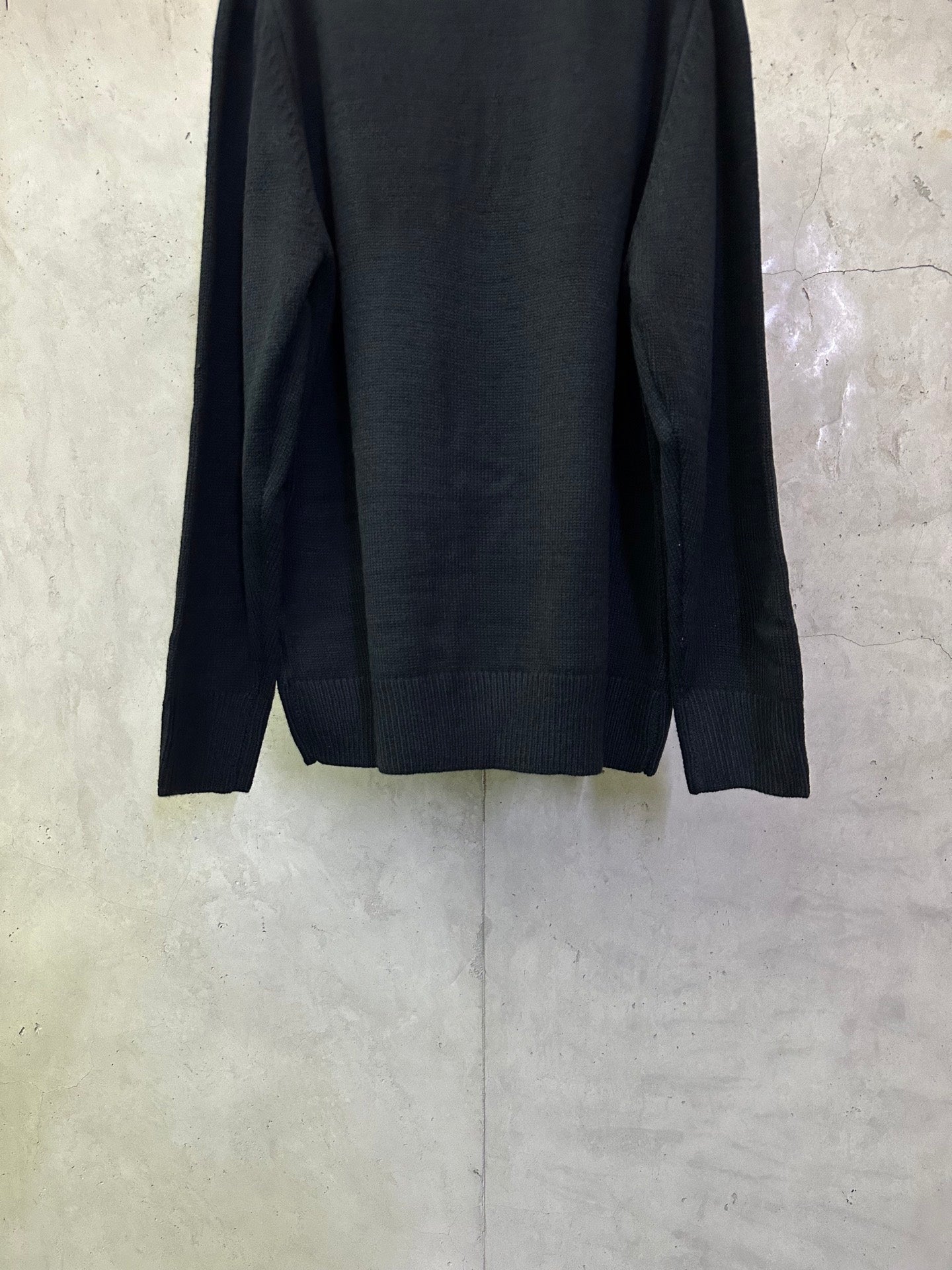Dark navy knit sweater back view with ribbed hem and long sleeves