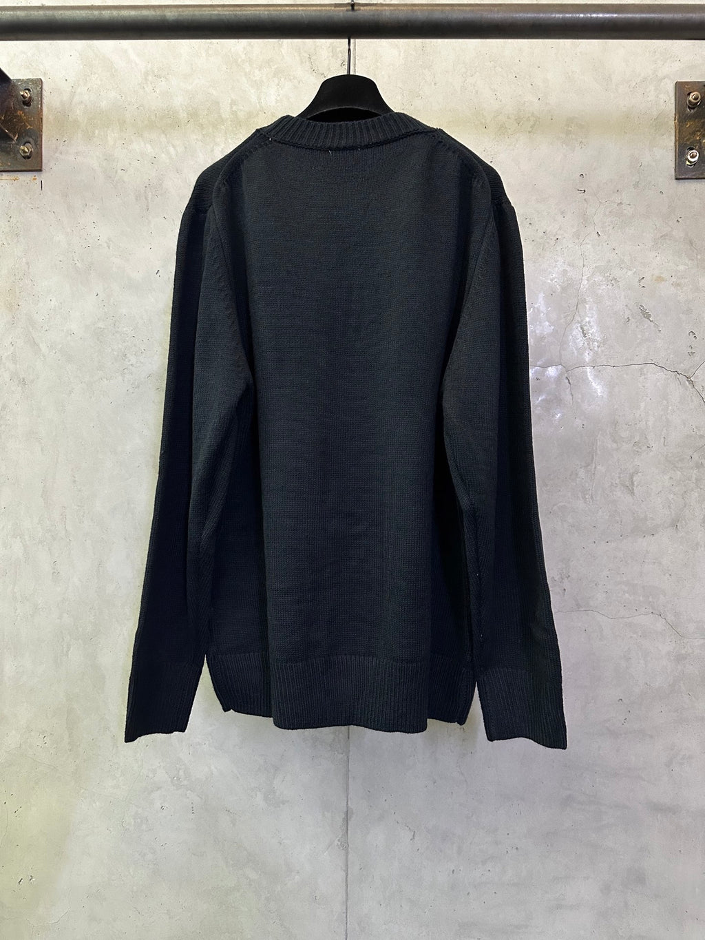 Dark navy knit sweater, crew neckline and ribbed hem, back view