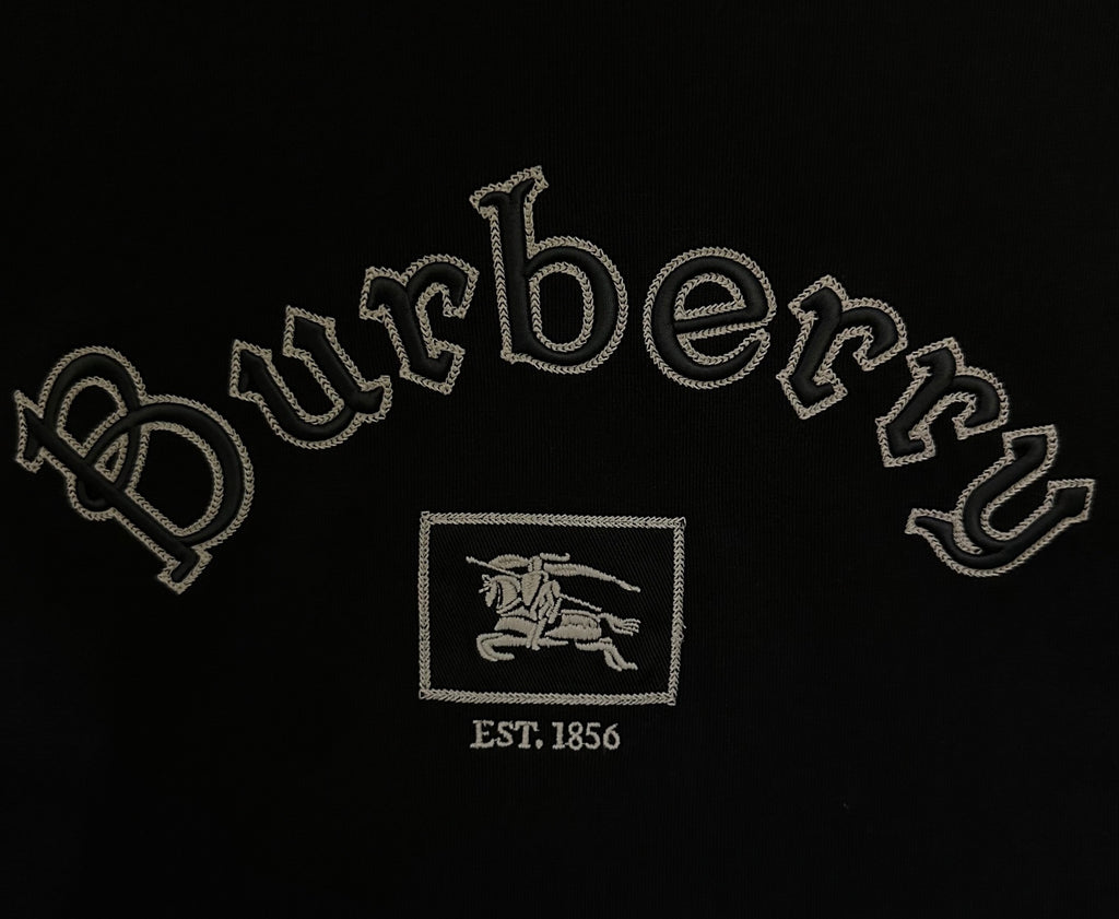 Close-up of Burberry logo embroidery with EST 1856 on black T-shirt