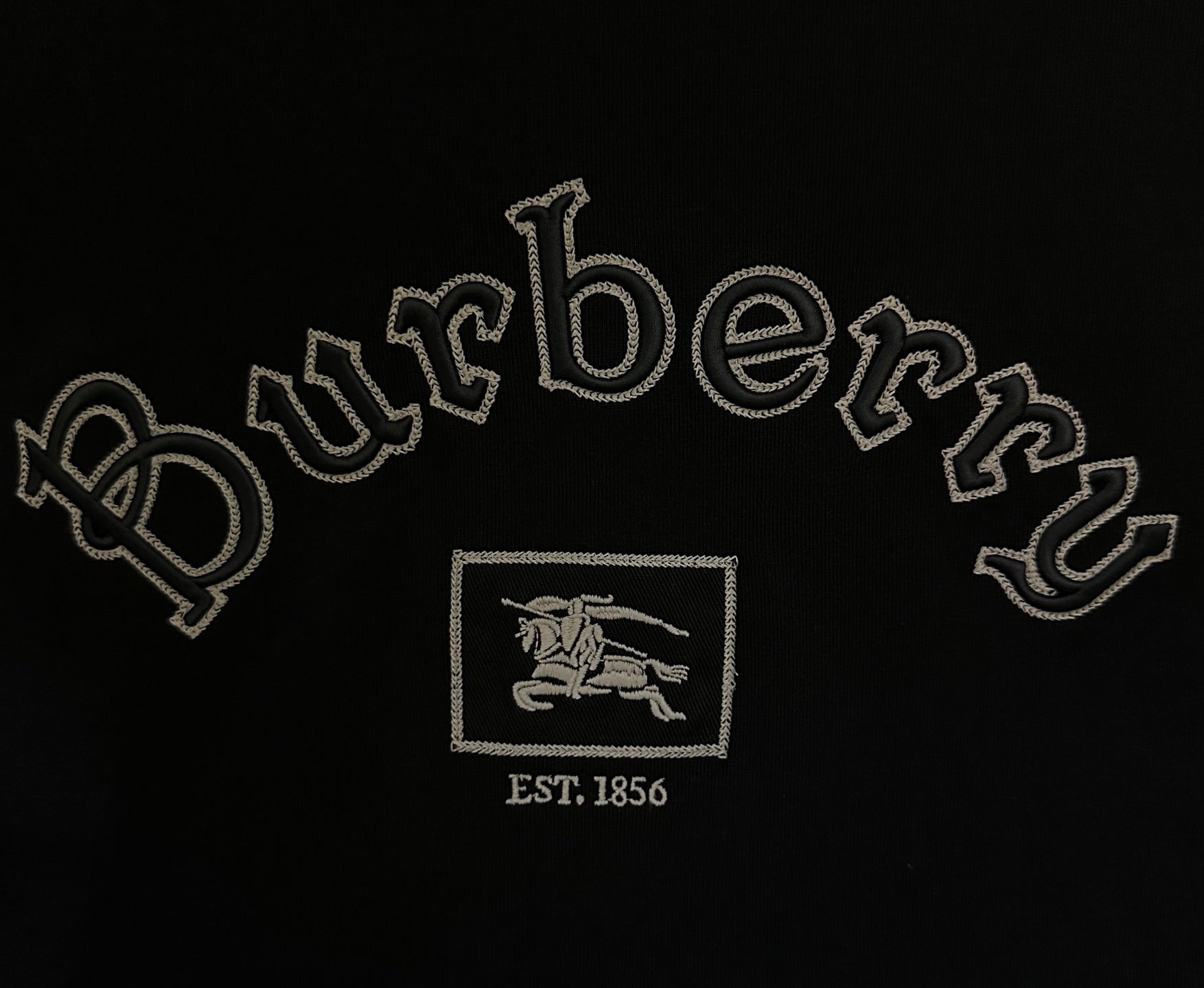 Close-up of Burberry logo embroidery with EST 1856 on black T-shirt