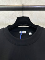 Black crewneck T-shirt neckline with Burberry size tag inside collar