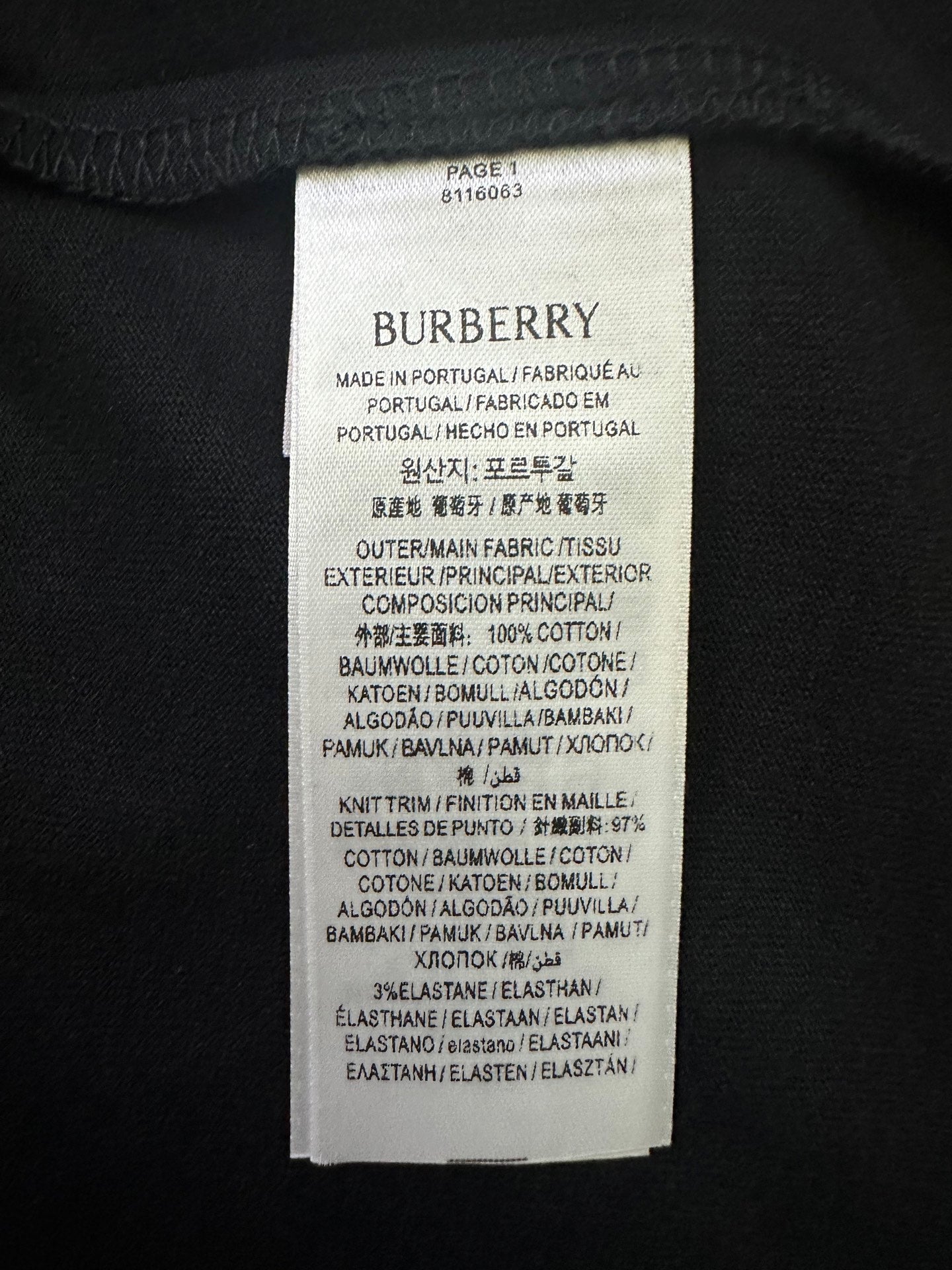 White Burberry fabric care label with product and material details