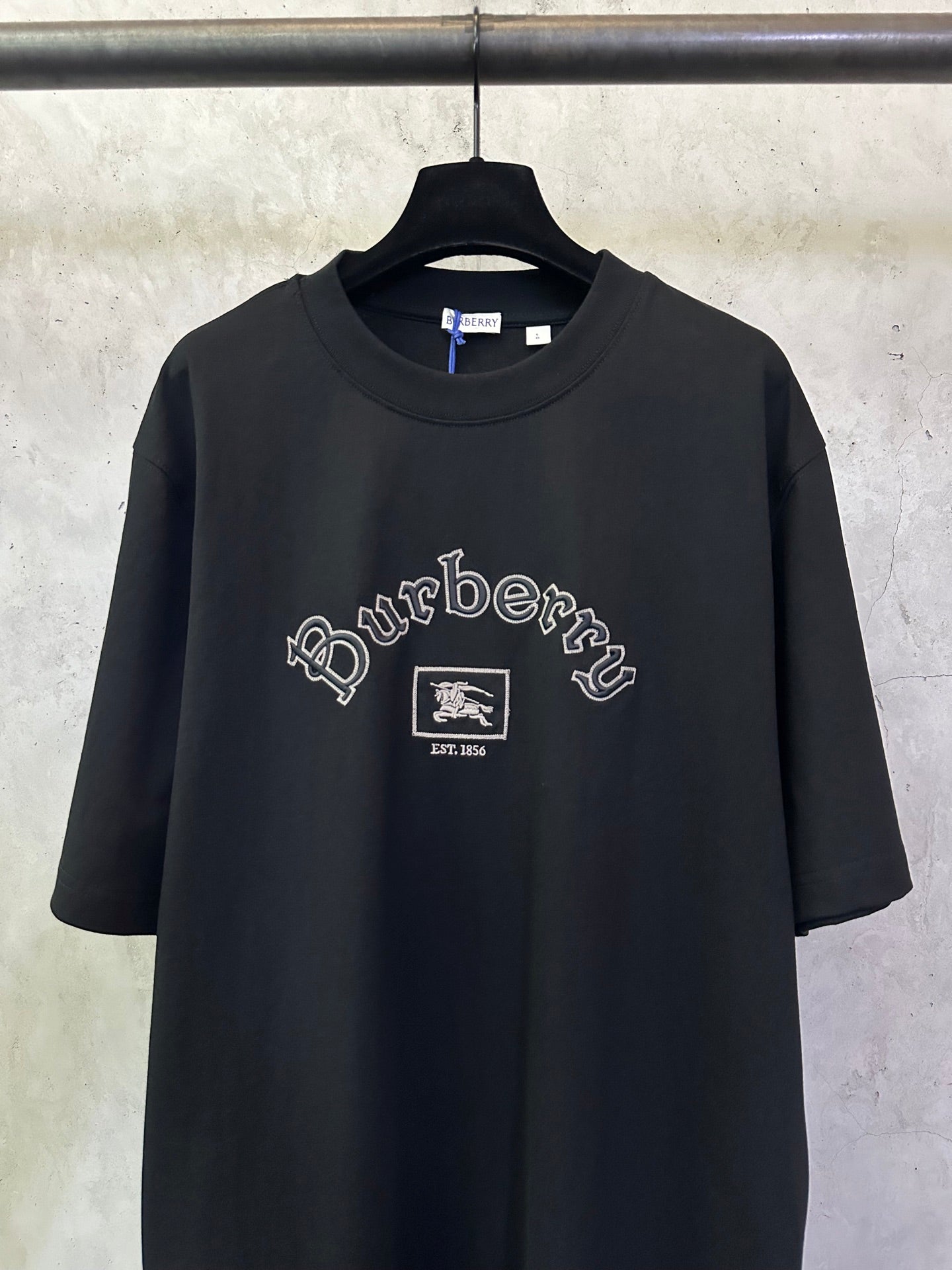 Black crewneck short-sleeve T-shirt with large Burberry logo and emblem