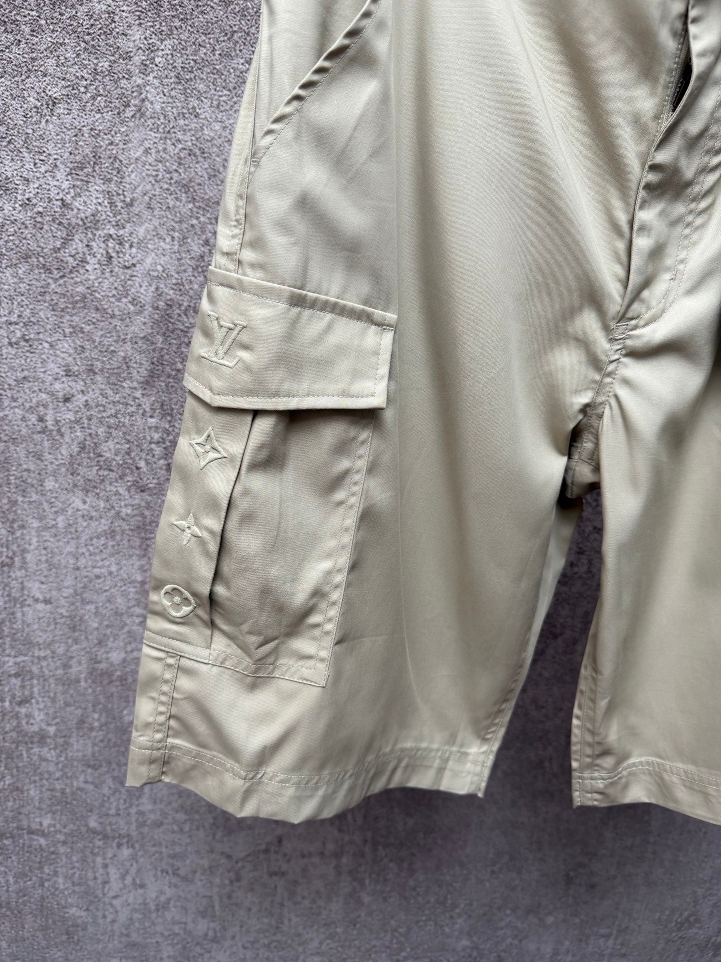 Light beige cargo shorts leg with snap button flap pocket