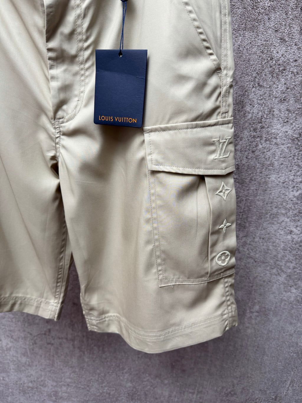 Light beige cargo shorts with front button, patch pockets, Louis Vuitton tag