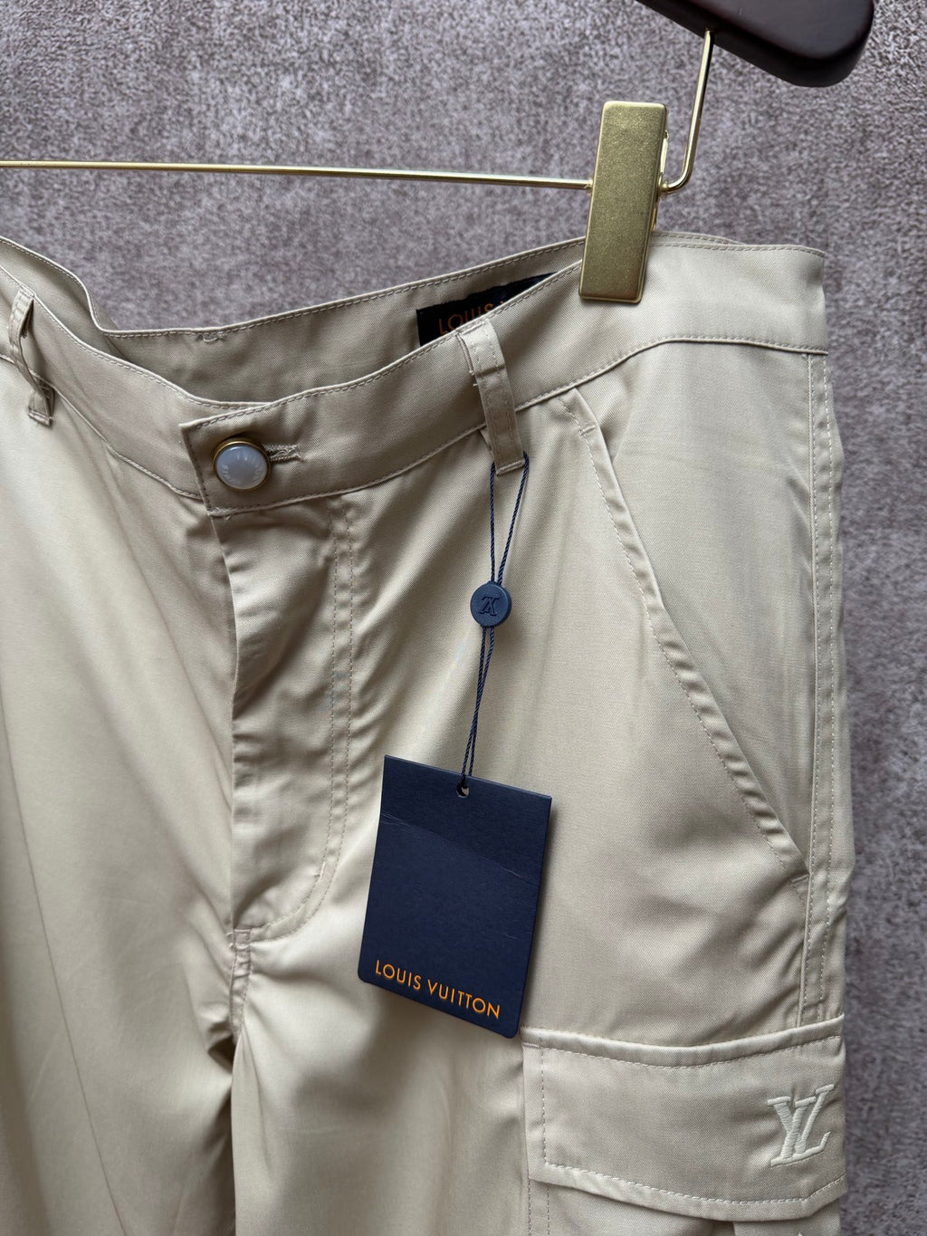 Light beige cargo shorts with drawstring waist and patch pockets, Louis Vuitton label