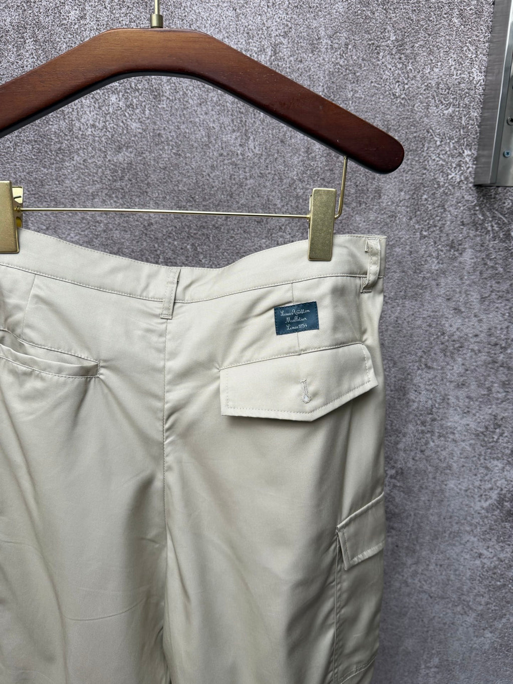 Light beige cargo shorts with rear patch pockets and belt loops
