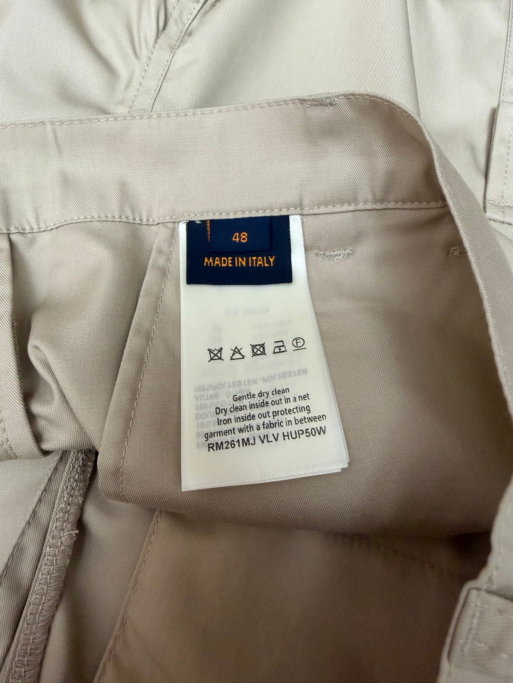 Light beige shorts size label with 'Made in Italy' and care symbols