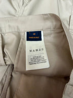 Light beige shorts size label with 'Made in Italy' and care symbols