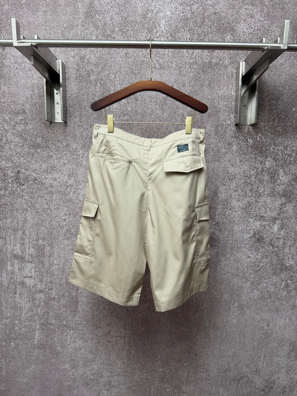 Light beige cargo shorts with belt loops, button fly, side pocket