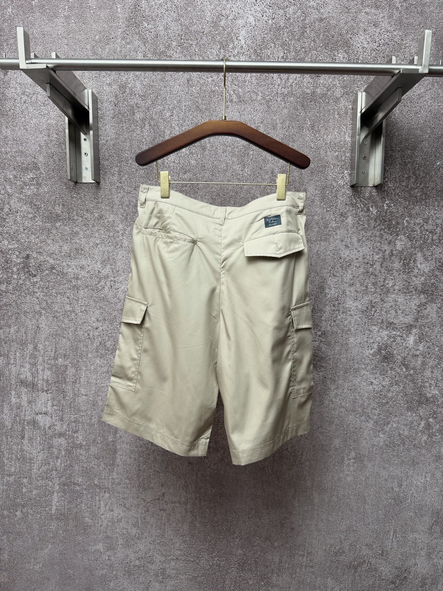 Light beige cargo shorts with belt loops, button fly, side pocket