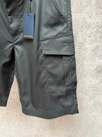 Cargo shorts pocket close-up with Louis Vuitton logo and star appliques