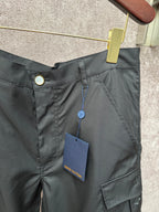 Black cargo shorts waist with button and hanging tag, front cargo pocket