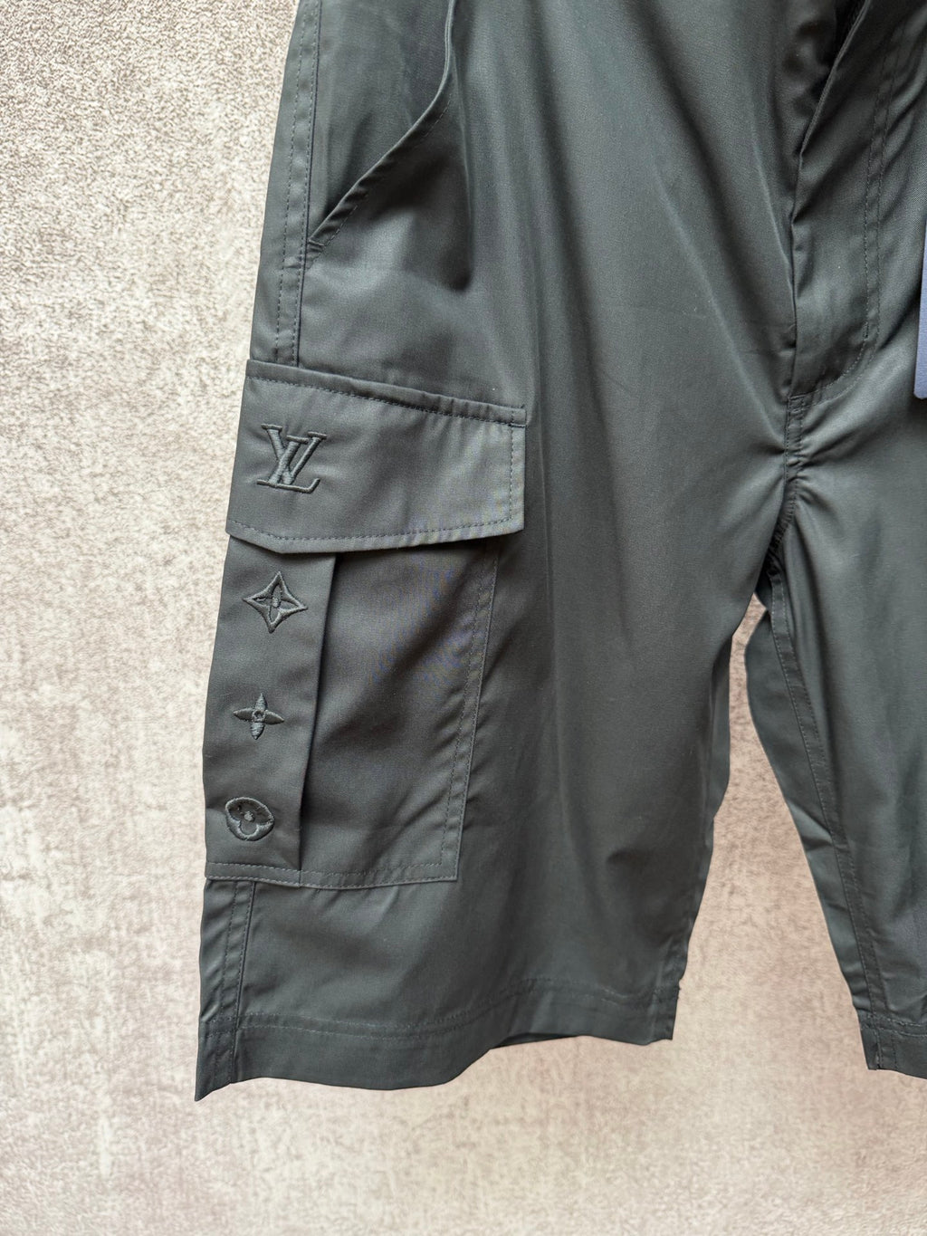 Cargo shorts side view with flap pocket and Louis Vuitton logo embroidery