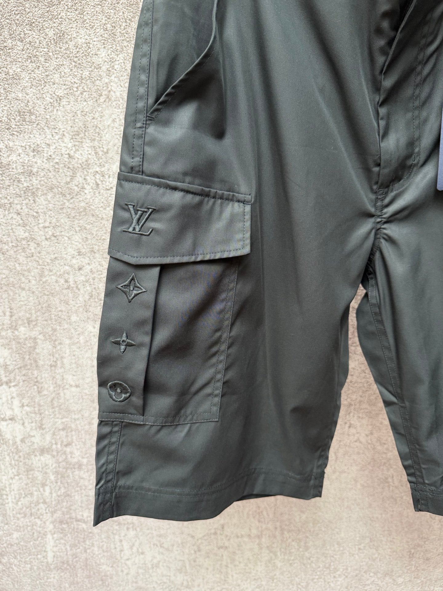 Cargo shorts side view with flap pocket and Louis Vuitton logo embroidery