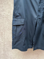 Dark blue cargo shorts detail with flap pocket and small embroidered icons on side