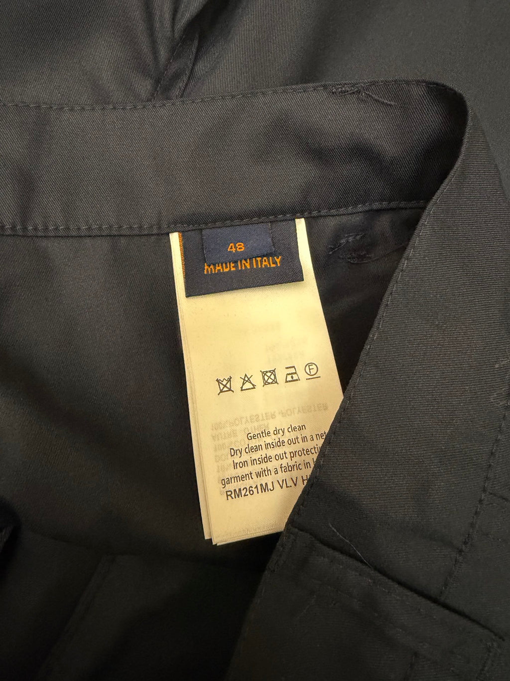 Louis Vuitton care label inside dark blue shorts, marked Made in Italy