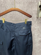 Dark blue cargo shorts front view with belt loops and flap side pocket