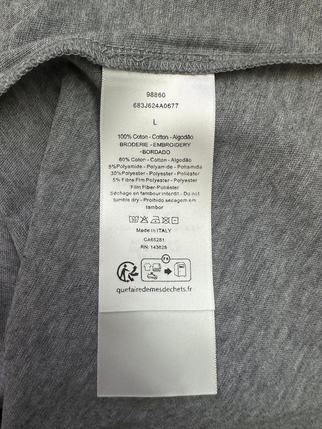 Inside clothing label on heather gray T-shirt with size L and fabric details