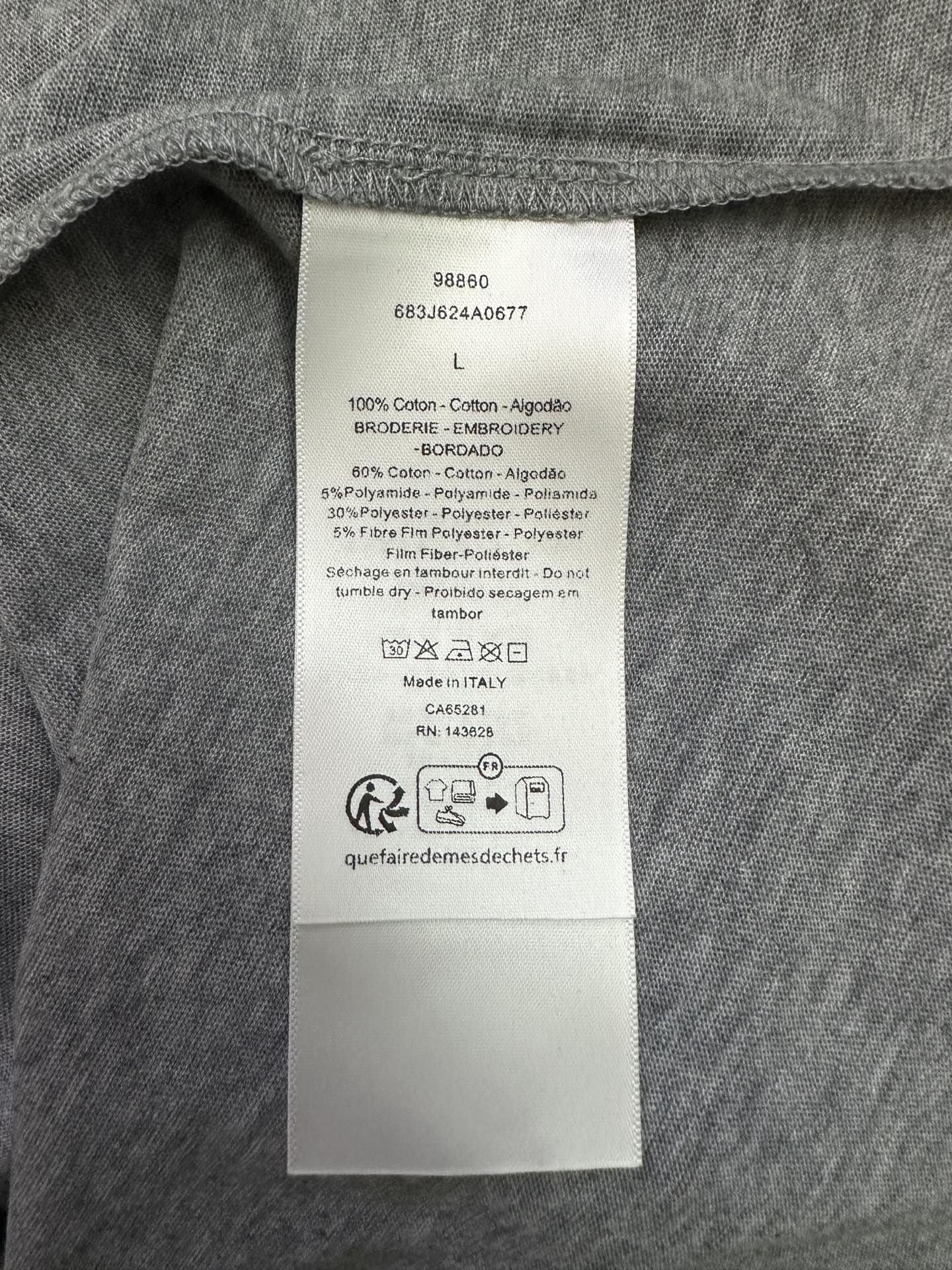 Inside clothing label on heather gray T-shirt with size L and fabric details