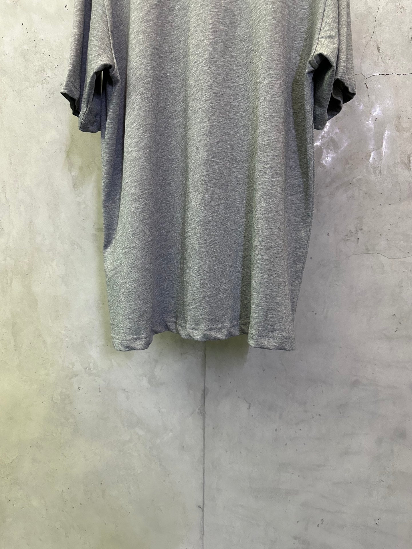 Heather gray short-sleeve T-shirt back view with draped sleeves
