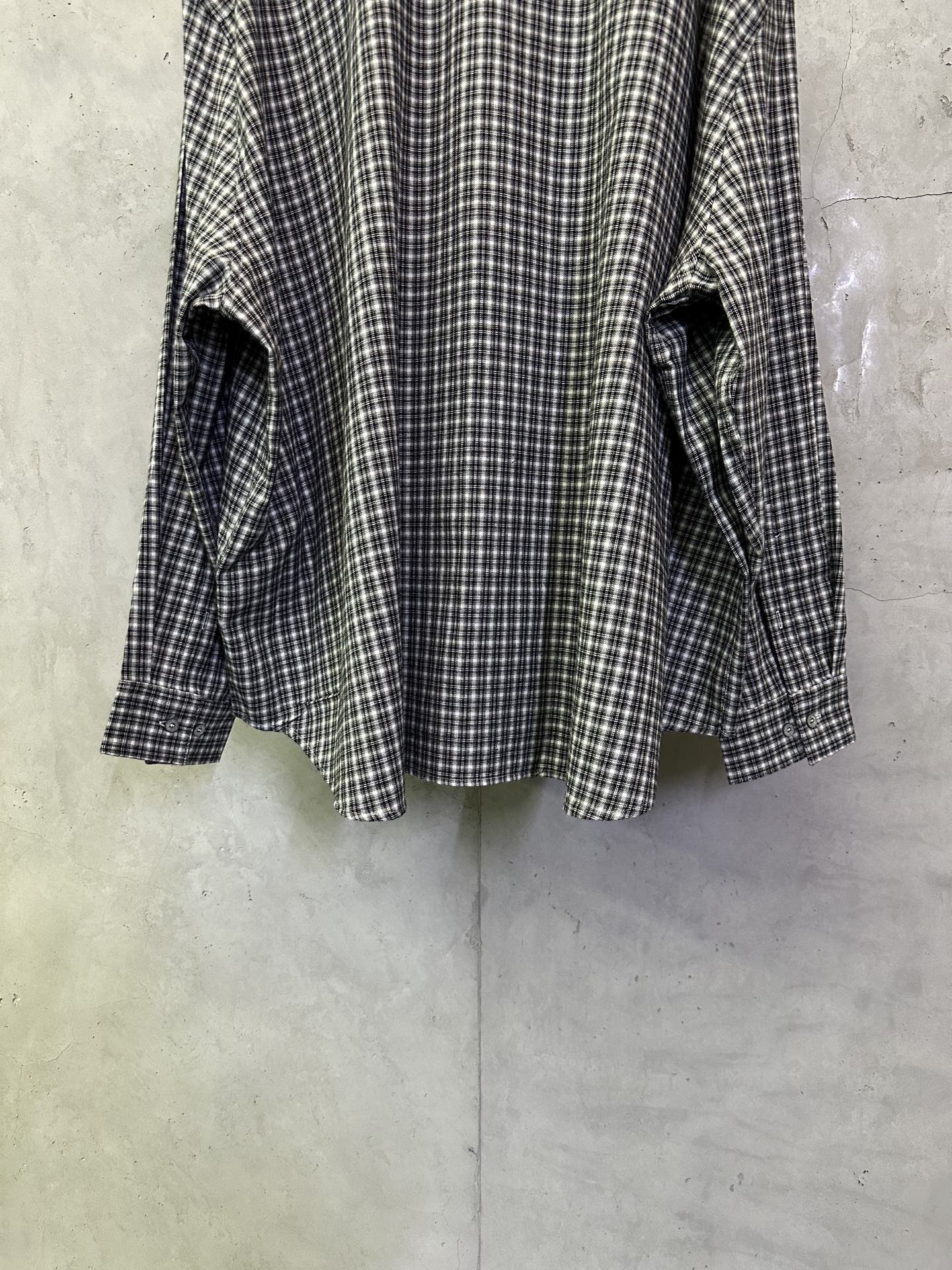 Balenciaga long plaid long-sleeve shirt, side view showing cuffs and hem