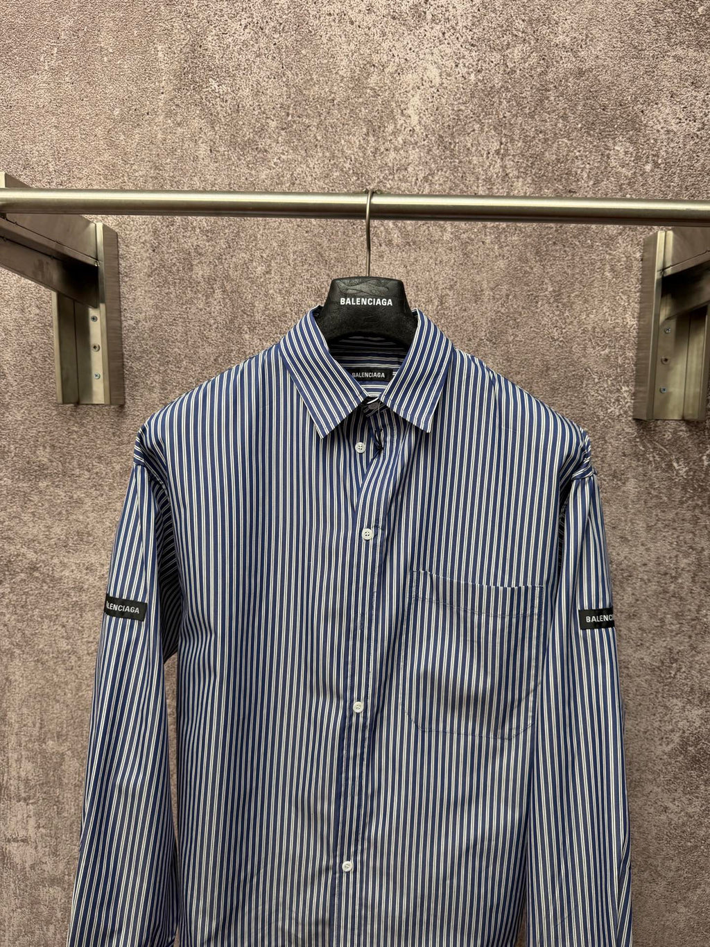 Long-sleeve striped button-up shirt with chest pocket and front buttons, logo collar label.