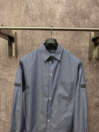 Long-sleeve striped button-up shirt with chest pocket and front buttons, logo collar label.