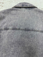 Light blue denim jacket back yoke with top-stitched seam and collar edge