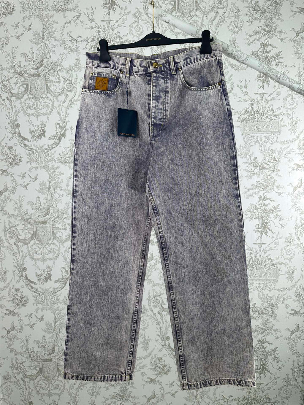 Light wash denim jeans with multiple front pockets and belt loops