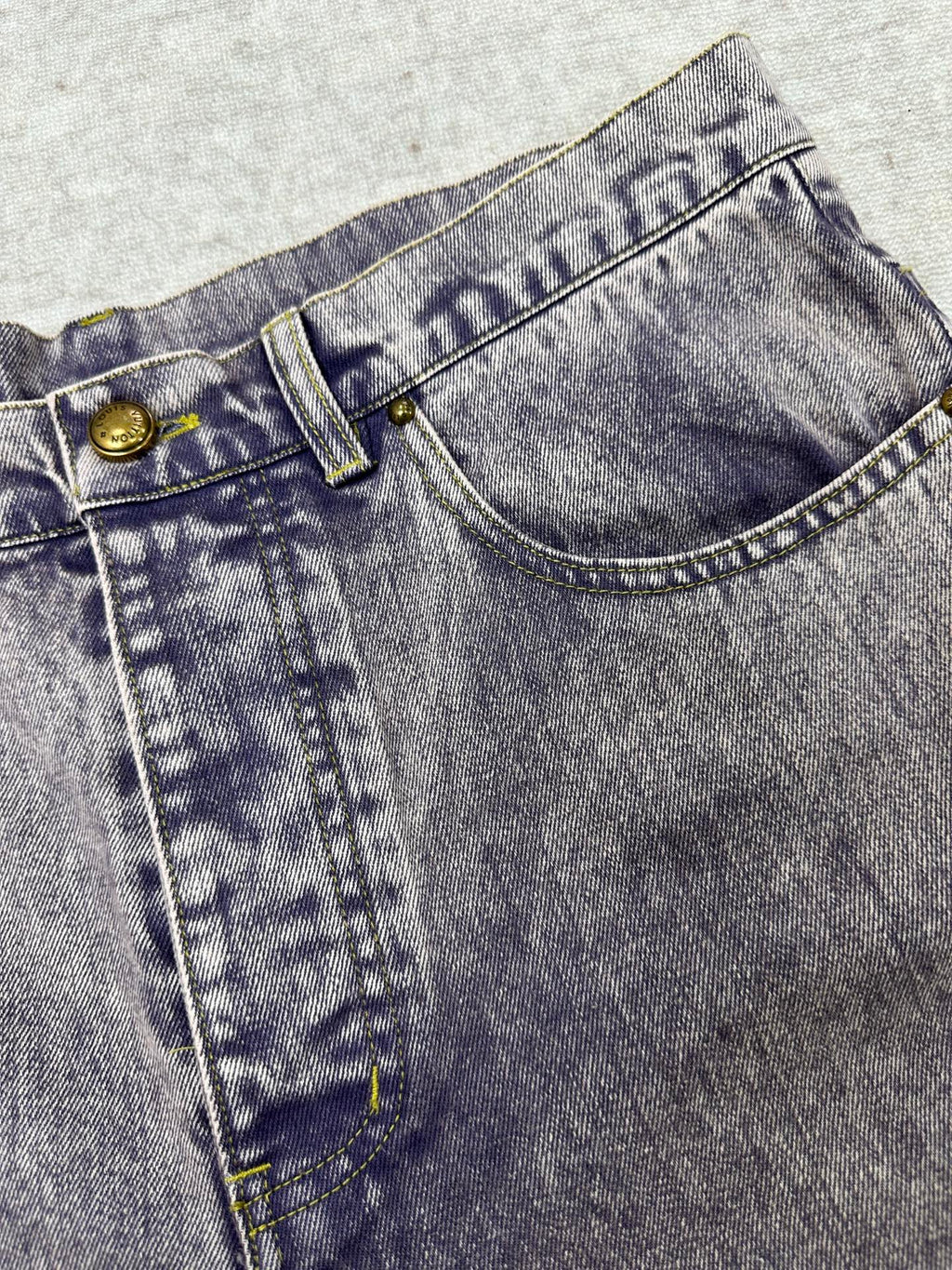 Denim jeans front yoke with button closure and pocket stitch details