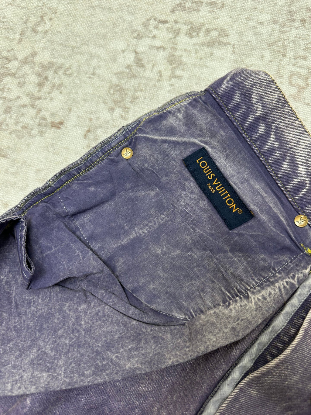 Blue-wash denim jeans with back yoke seam and Louis Vuitton leather tag